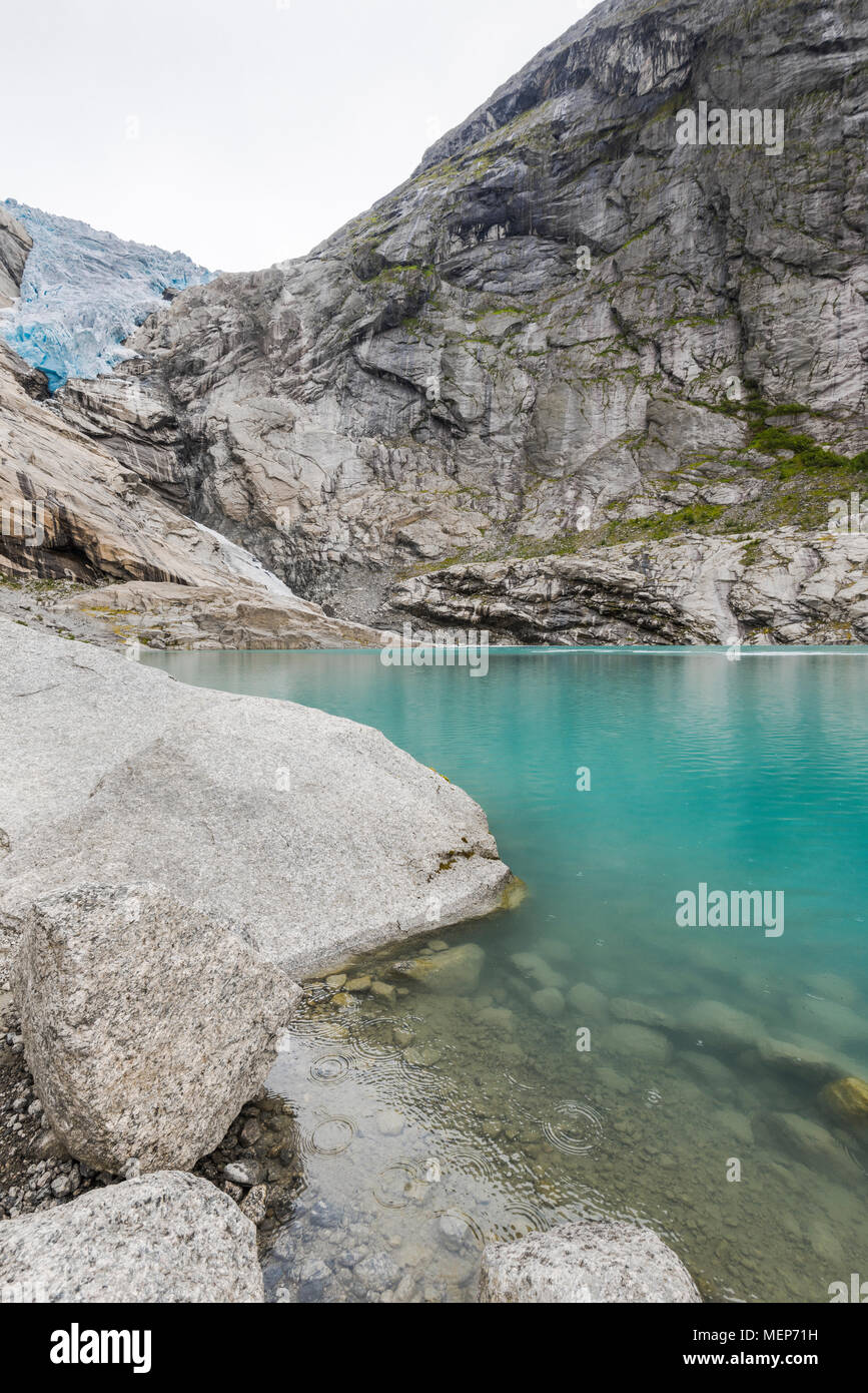 glacier Briksdalsbreen and its lake, Norway, arm of the Jostedal glacier, Oldedalen, Olden at the Nordfjorden, raindrops in turquoise glacial water Stock Photo