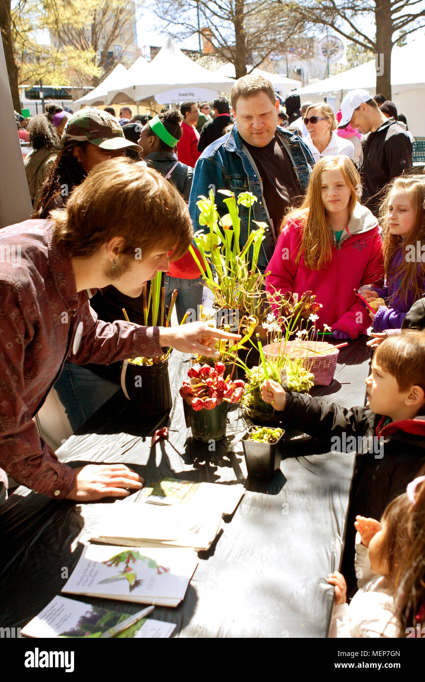 An instructor explains facts about carnivorous plants to kids looking at a display at the Atlanta Science Fair on March 28, 2015 in Atlanta, GA. Stock Photo