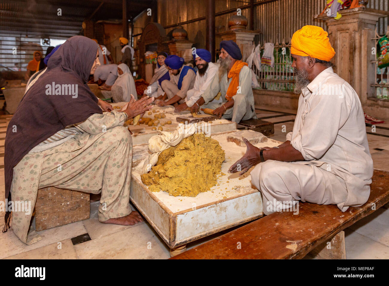 People working in the community kitchen, The Golden Temple (Harmandir Sahib), Punjab, India Stock Photo