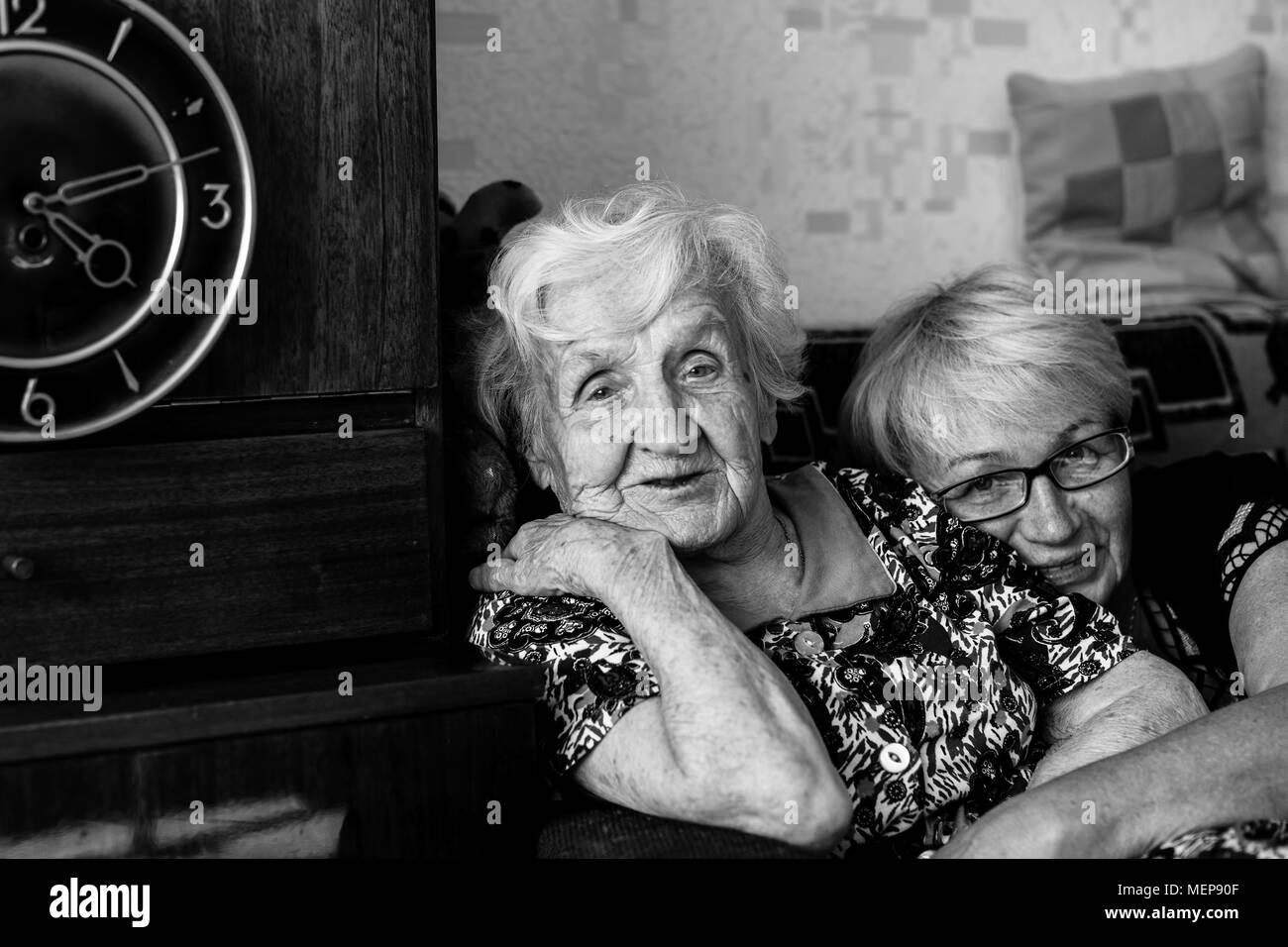Elderly woman in home with his adult daughter. Stock Photo
