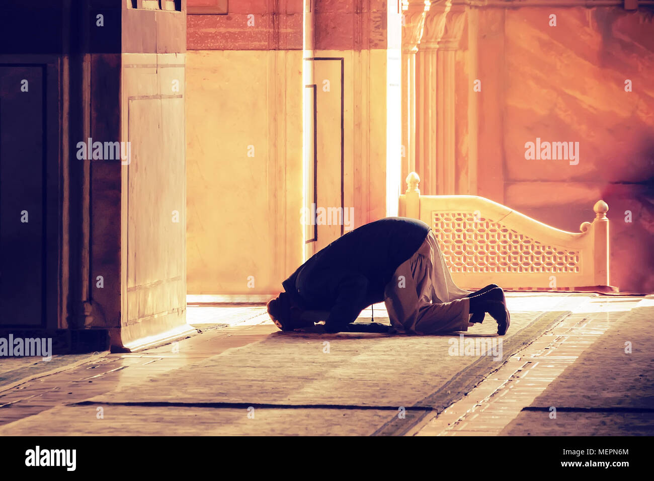 The muslim prayer for god in the mosque. Old iranian Muslim is on his knees praying. Holy month of Ramadan Muslims. Moslem, mohammedan, muslimah. monk Stock Photo