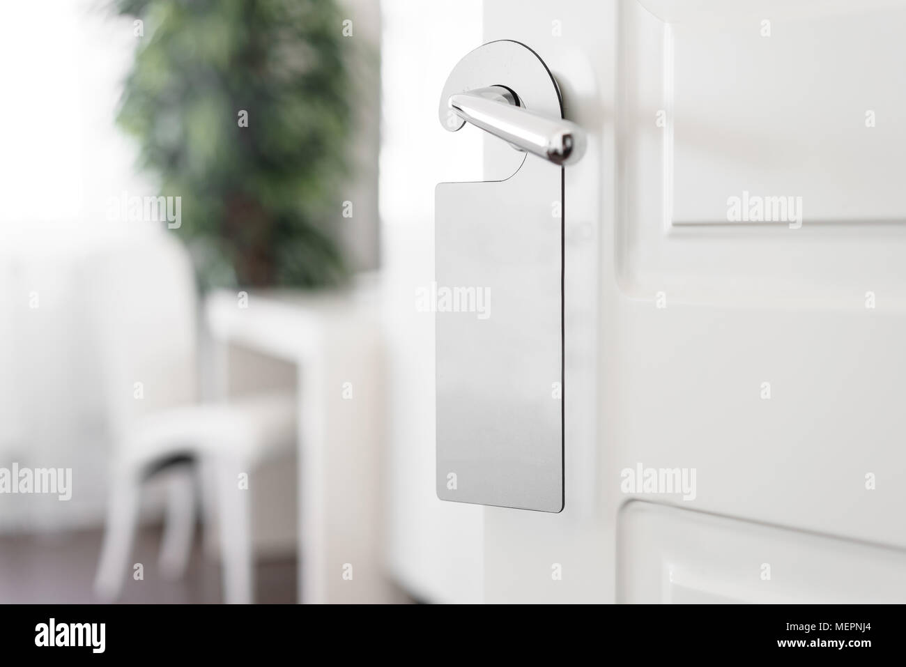 Door knob with empty label on a door handle for your text. Empty white