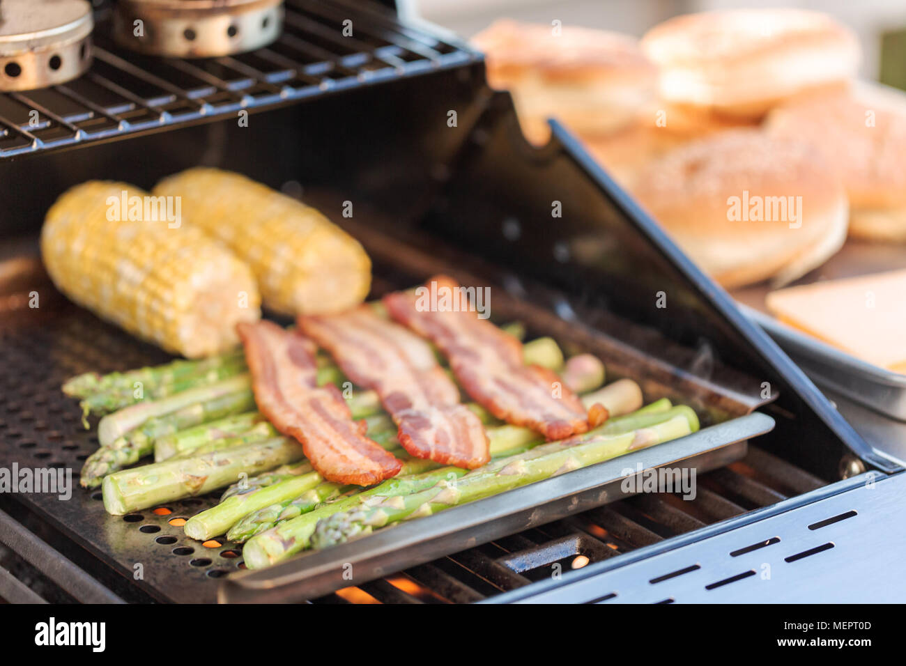 Step by step. Grilling asparagus on outdoor gas grill Stock Photo Alamy
