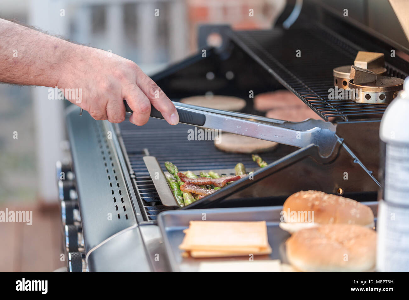Step by step. Cooking hamburgers on outdoor gas grill in the Summer