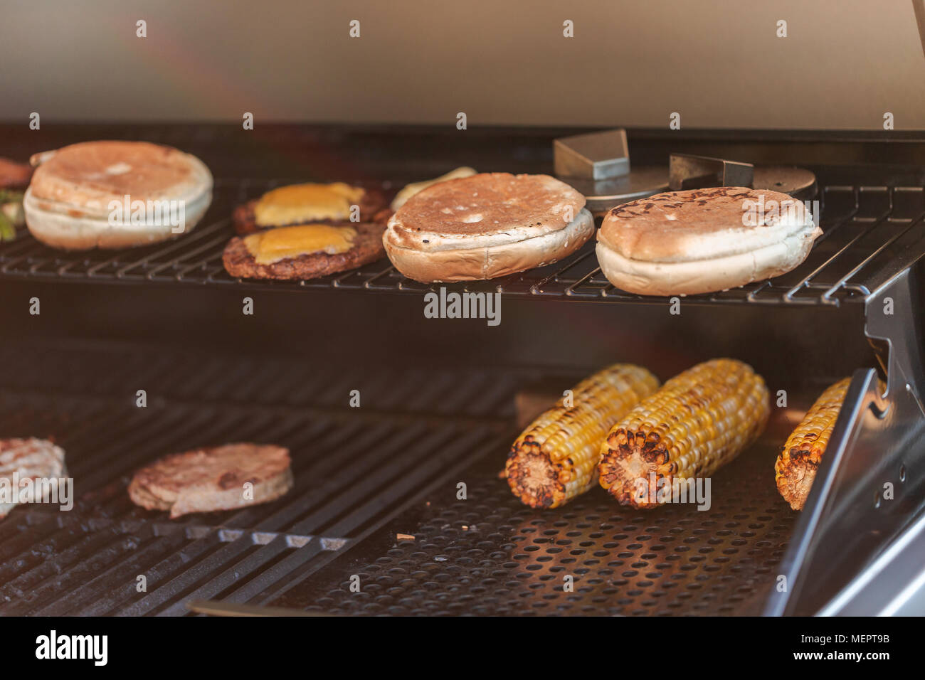 Step by step. Cooking hamburgers on outdoor gas grill in the Summer
