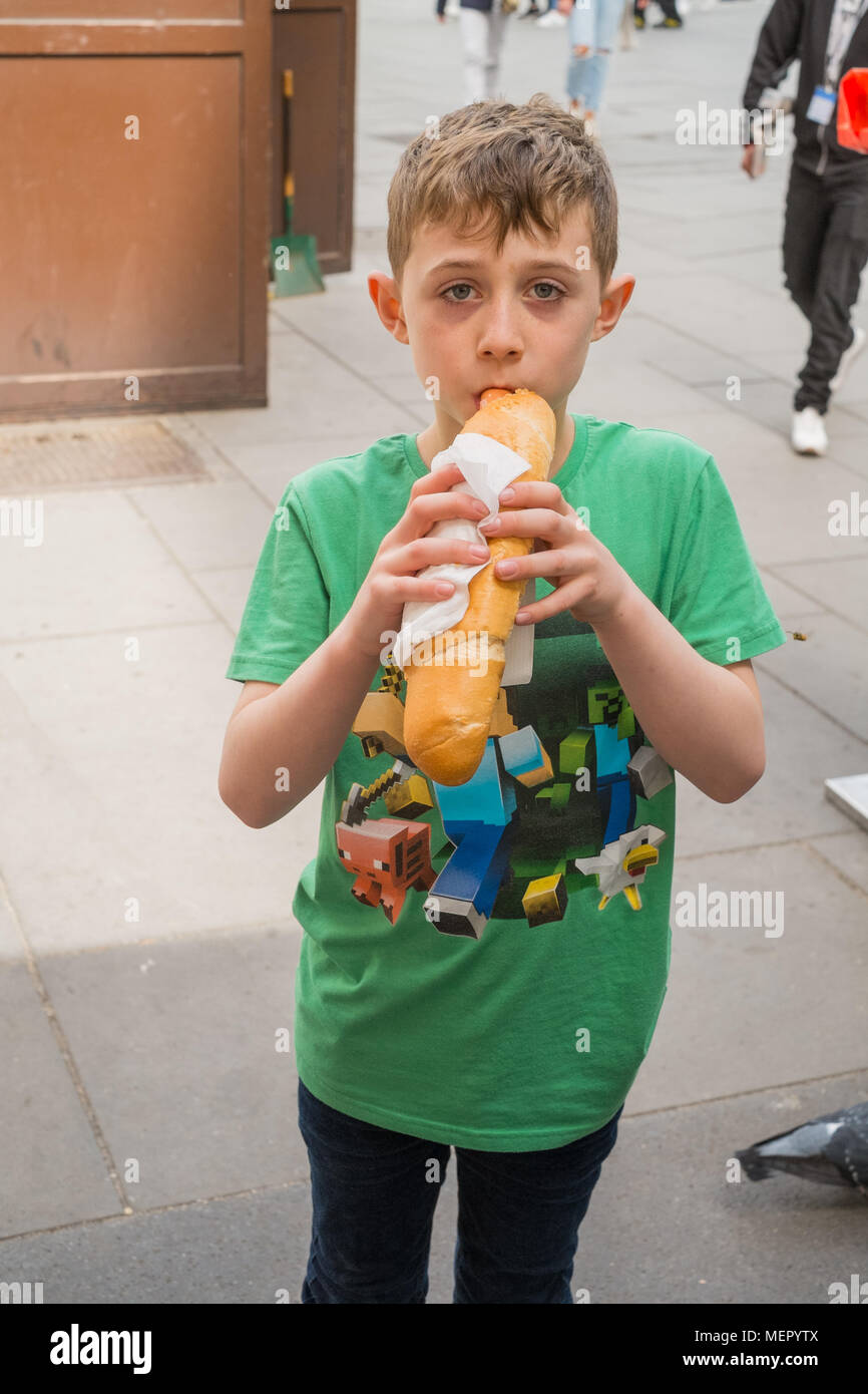 Eight Year old boy with a hot-dog sausage at Wiener Wurstl sausage stall on Graben Street  Vienna Austria Europe. Stock Photo
