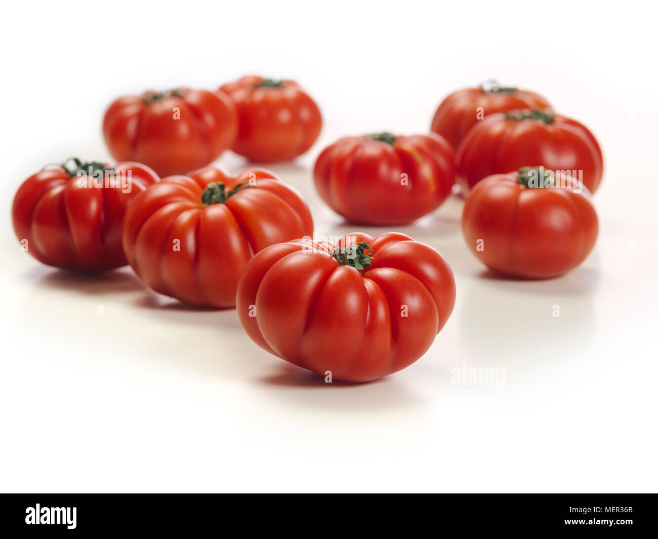 Photo of a white table top with Marmande tomatoes. Stock Photo