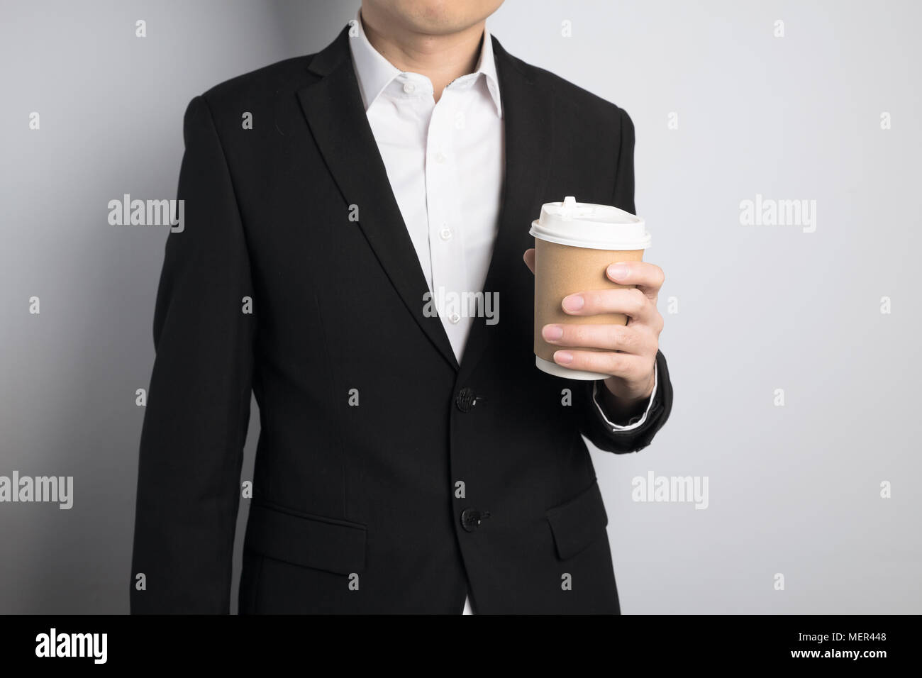 business man holding a paper cup Stock Photo - Alamy
