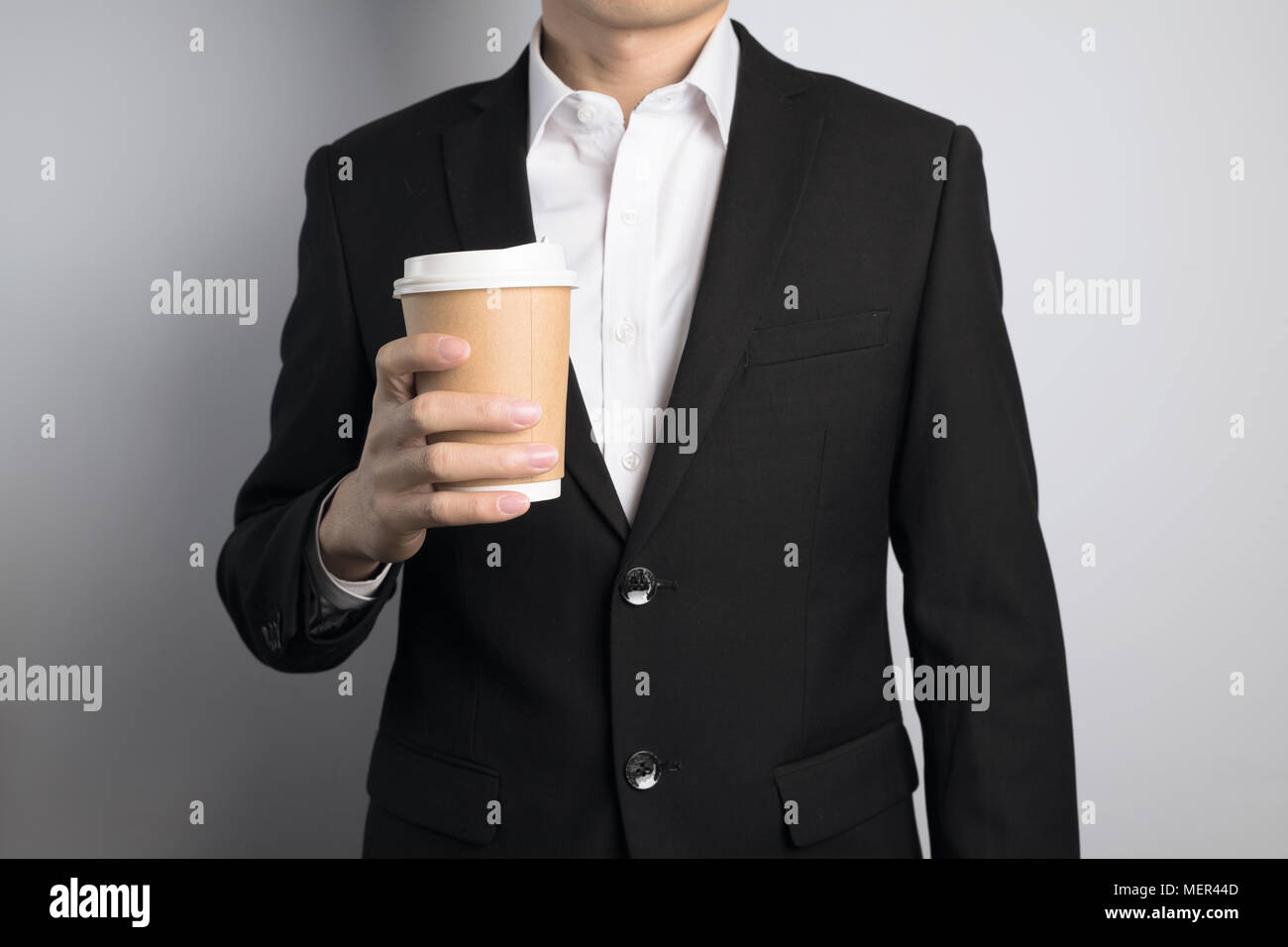 business man holding a paper cup Stock Photo