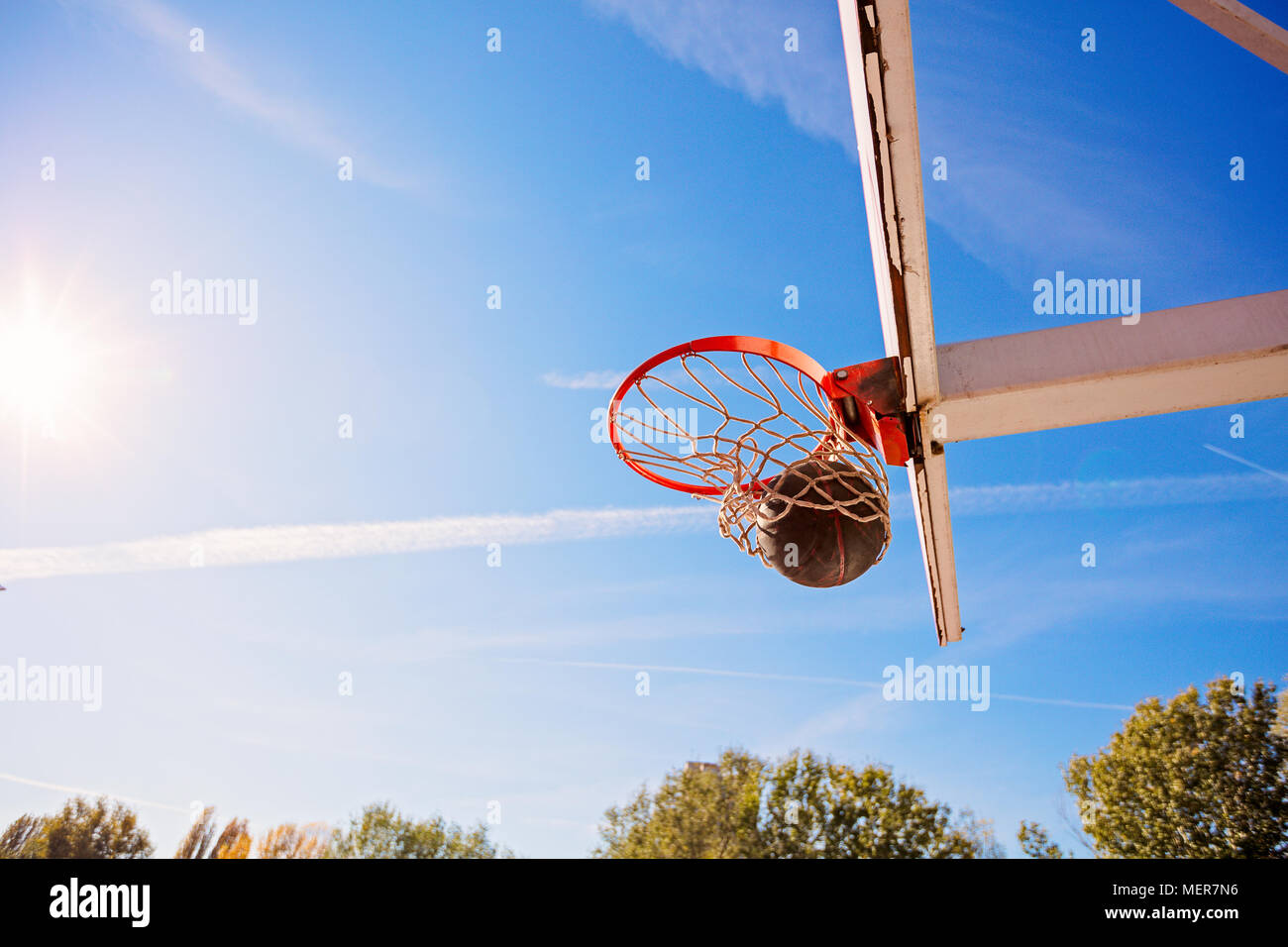 basketball close up, basketball bal in hoop at sunny day Stock Photo