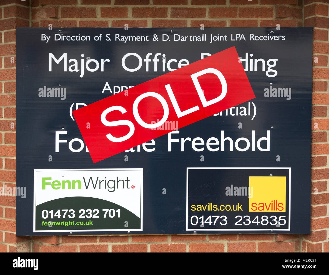 Close up of Sold estate agent sign for major office building commercial