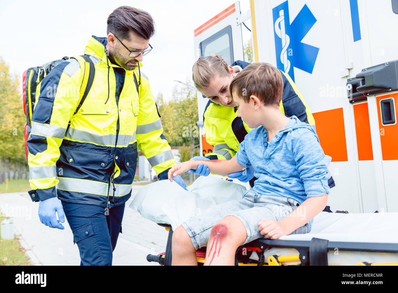 Emergency doctors caring for accident victim boy Stock Photo Alamy
