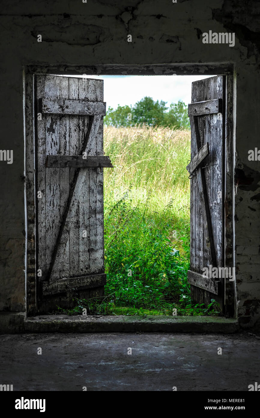 Open Wood Door In Abandoned House Green Sunny Meadow Outside Stock Photo Alamy