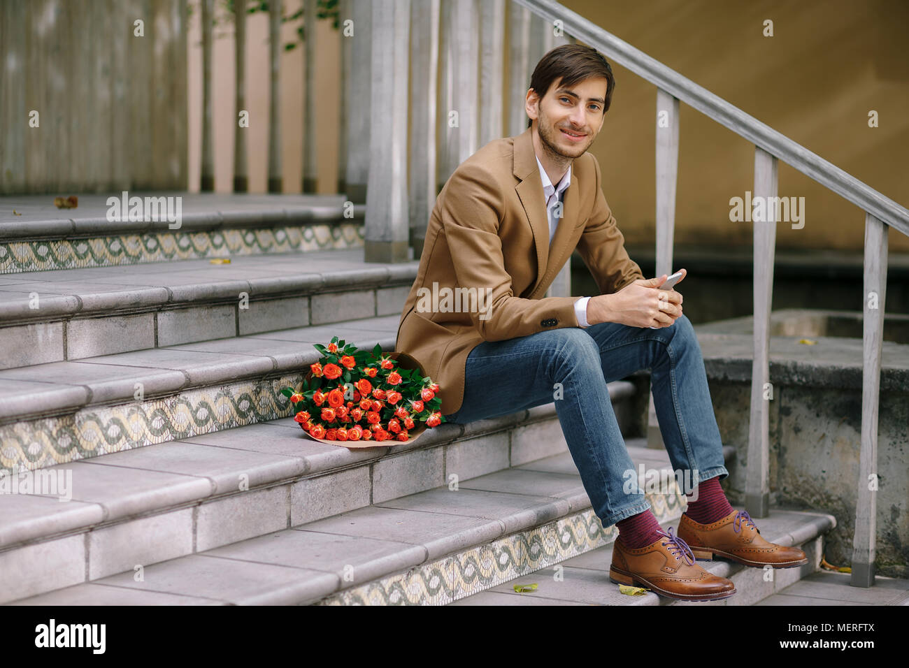Handsome man with bouquet of roses Stock Photo - Alamy