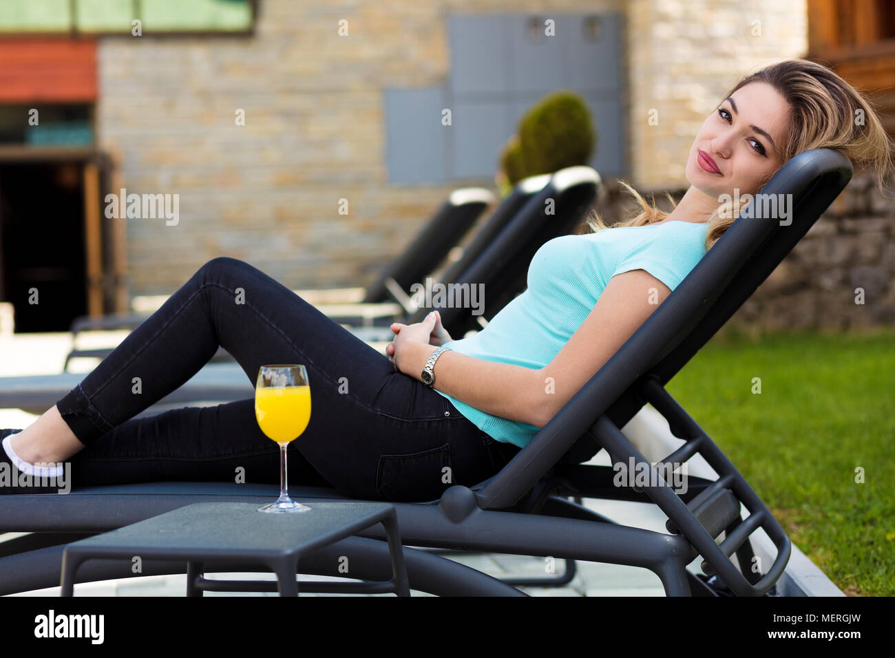 woman relaxing on lounger in the garden Stock Photo - Alamy