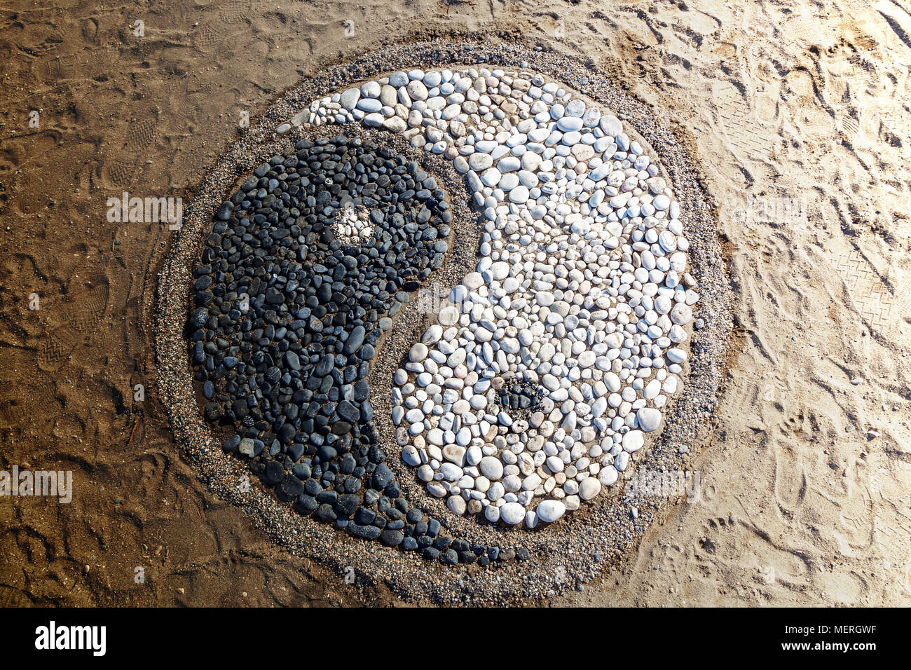The conception of yin and yang is laid with stones on the sand,Yin and