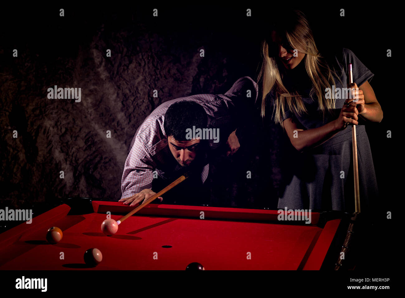 Young romantic couple playing billiard game Stock Photo