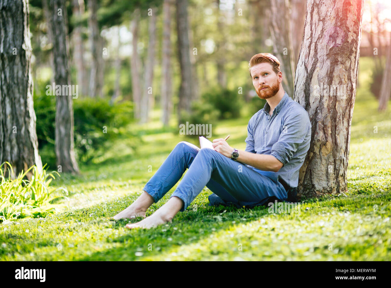 College student studying in park Stock Photo - Alamy