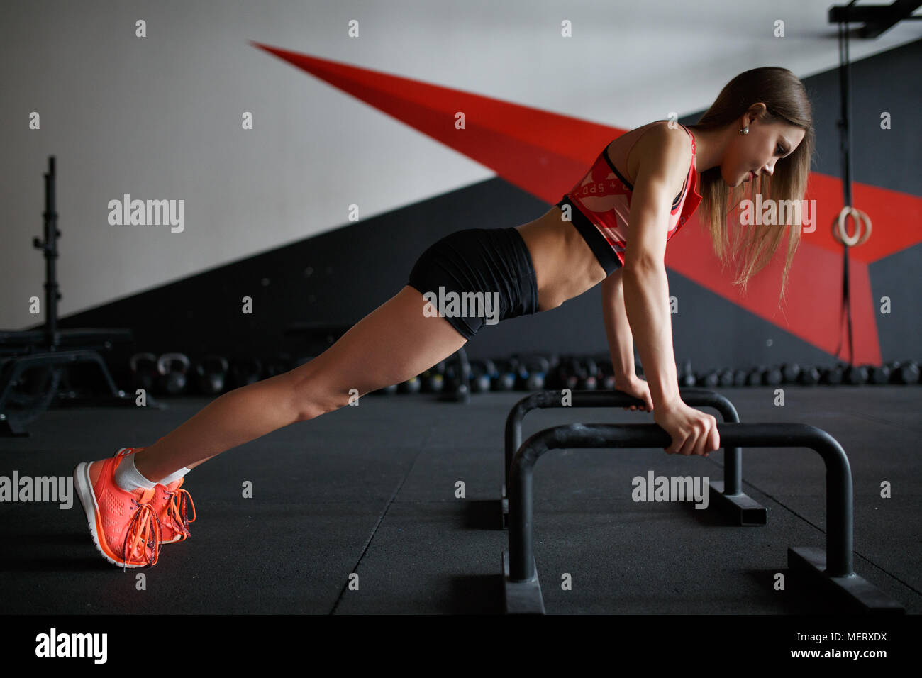 Photo side of sports woman pushing Stock Photo