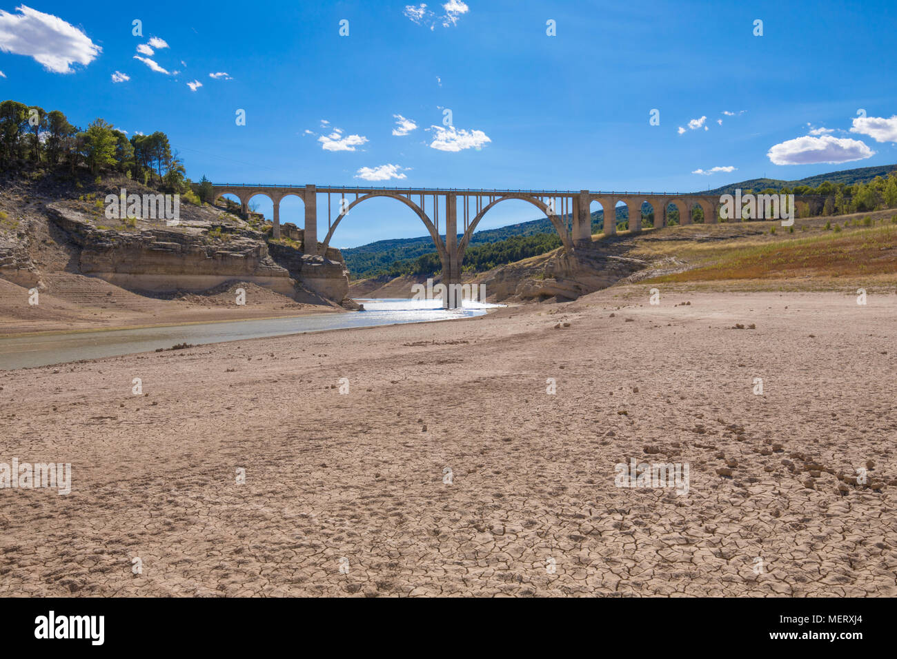 landscape of dry earth ground and bridge, extreme drought in Entrepenas reservoir, in Guadalajara, Castilla, Spain Europe Stock Photo