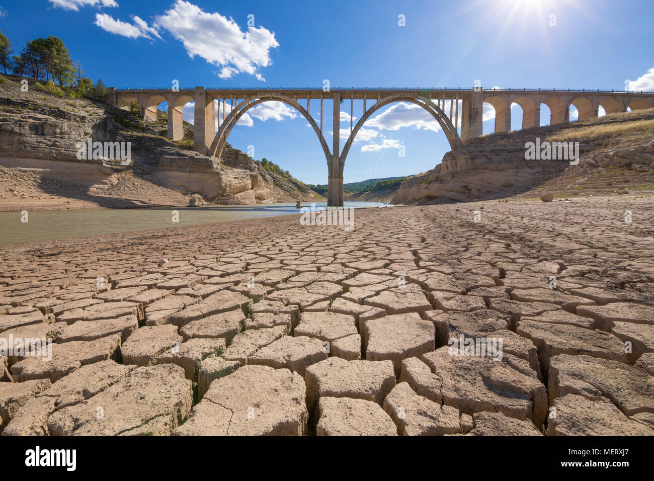 landscape of dry earth ground and viaduct, extreme drought in Entrepenas reservoir, in Guadalajara, Castilla, Spain Europe Stock Photo