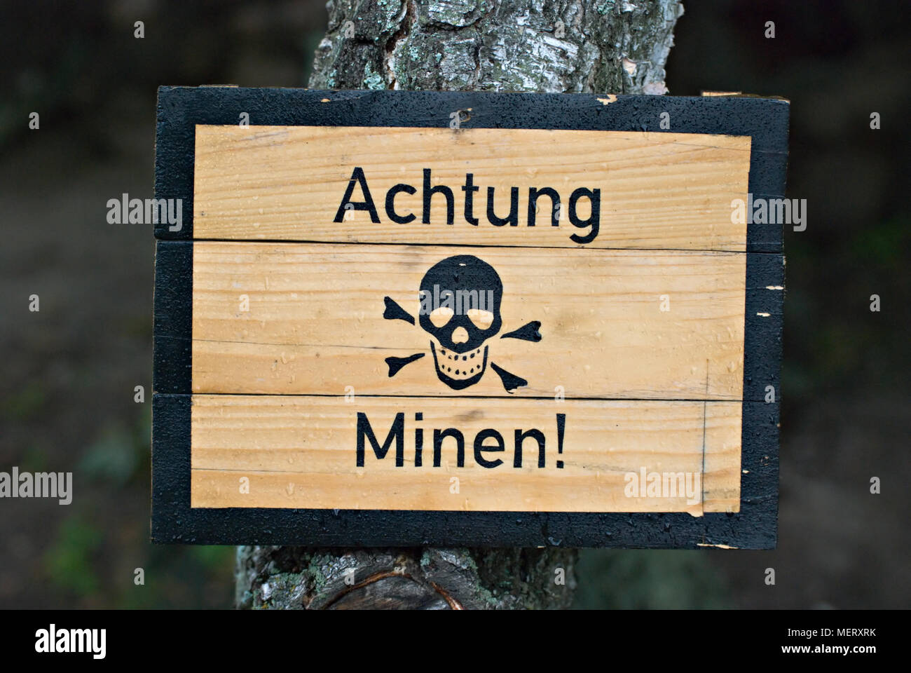 German land mines warning sign from World War Two, wet with water droplets. Stock Photo