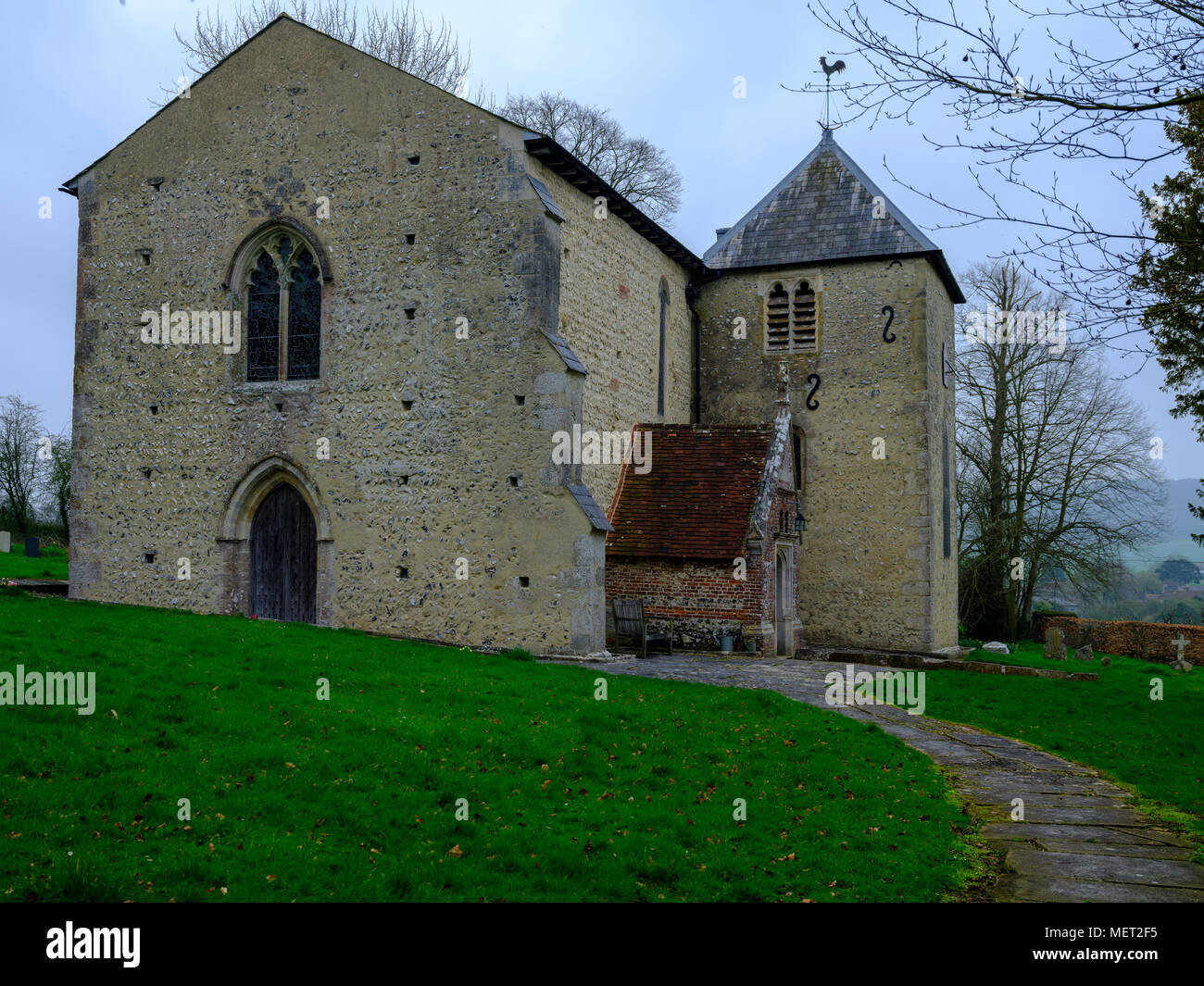 Spring view of St Mary's Church in Stoughton, West Sussex, UK Stock