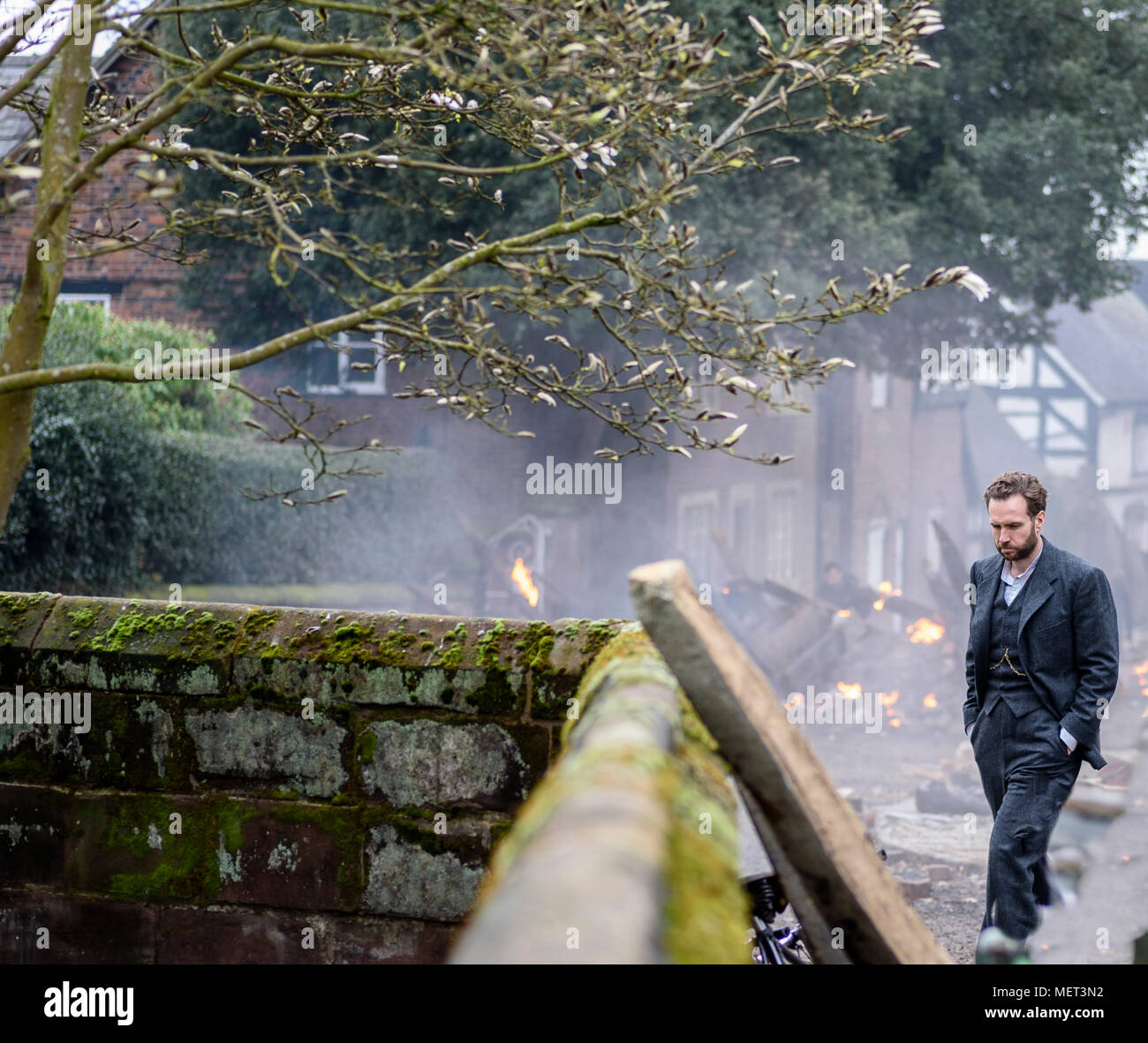 Great Budworth, UK. 11th April, 2018. Actor Rafe Spall waits between takes on set in the new BBC drama 'War Of The Worlds' by HG Wells, filmed in the  Stock Photo