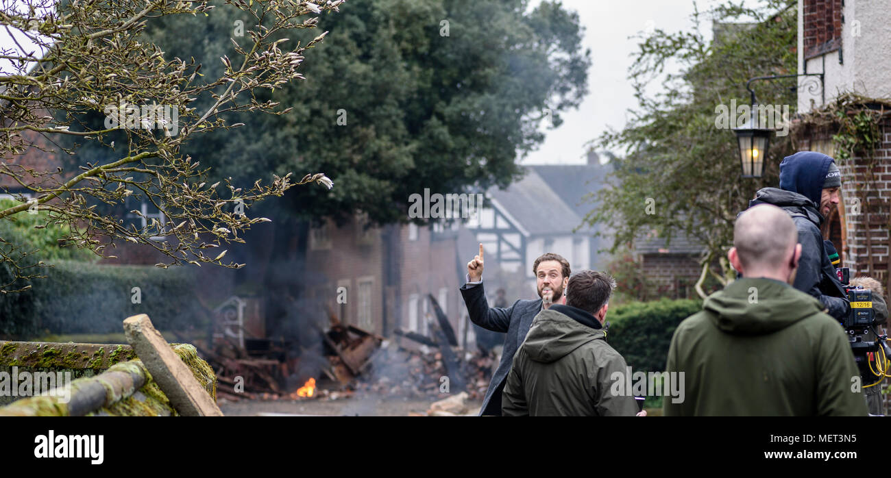 Great Budworth, UK. 11th April, 2018. Actor Rafe Spall with finger raised with an idea between takes on set in the new BBC drama 'War Of The Worlds' b Stock Photo