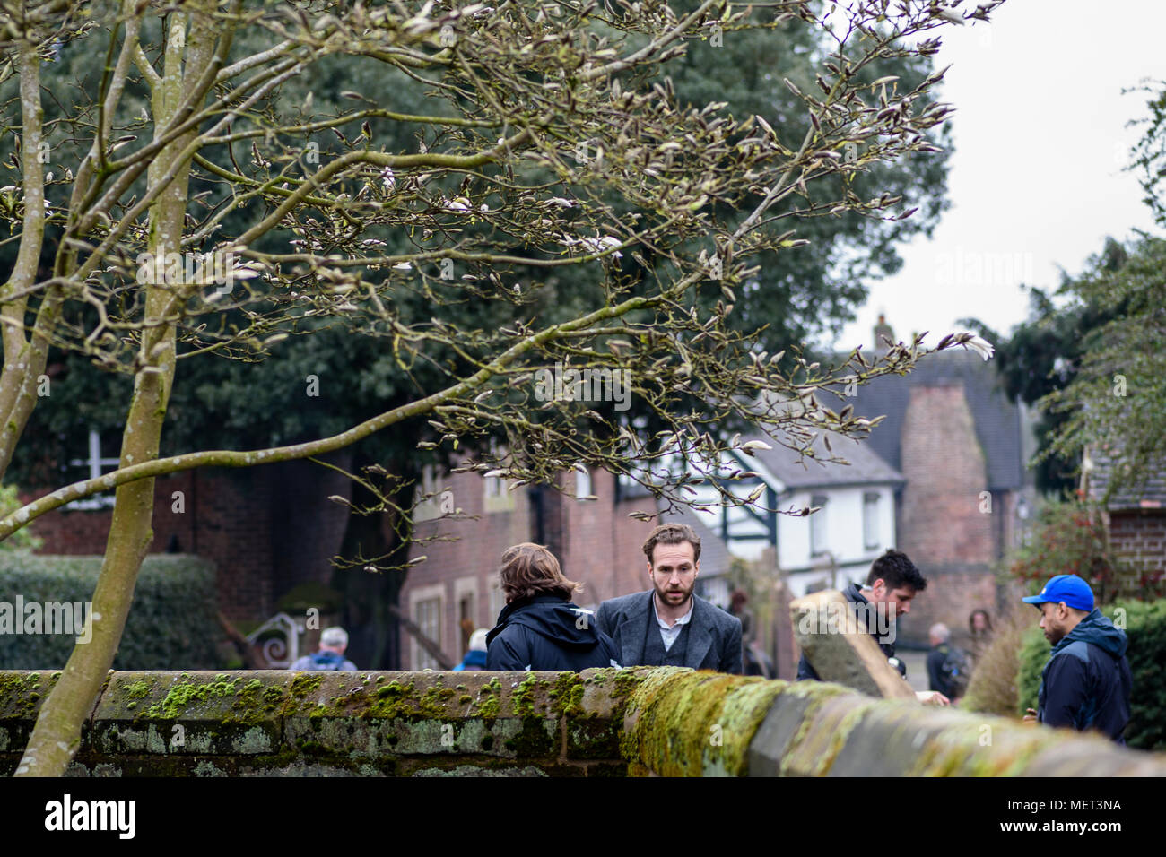 Great Budworth, UK. 11th April, 2018. Actor Rafe Spall waits between takes on set in the new BBC drama 'War Of The Worlds' by HG Wells, filmed in the  Stock Photo