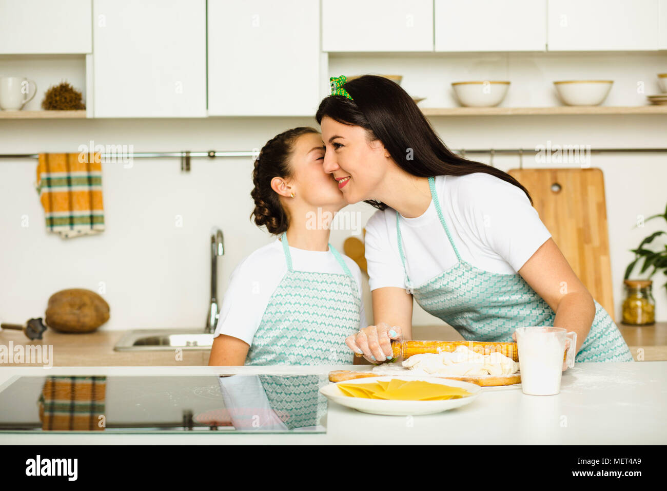 Mother and daughter Cooking at kitchen Stock Photo