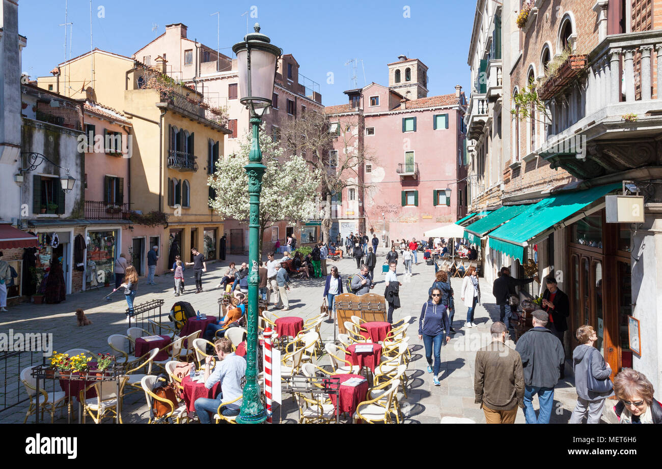 Campo Santa Maria Nova in spring, Cannaregio, Venice, Veneto, Italy, with people eating at an open air restaurant enjoying the sunshine, elevated view Stock Photo