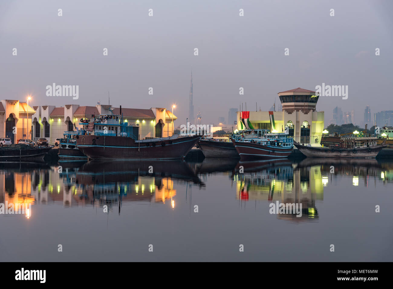 Small ships and dhows line the side of the creek in Dubai. Stock Photo
