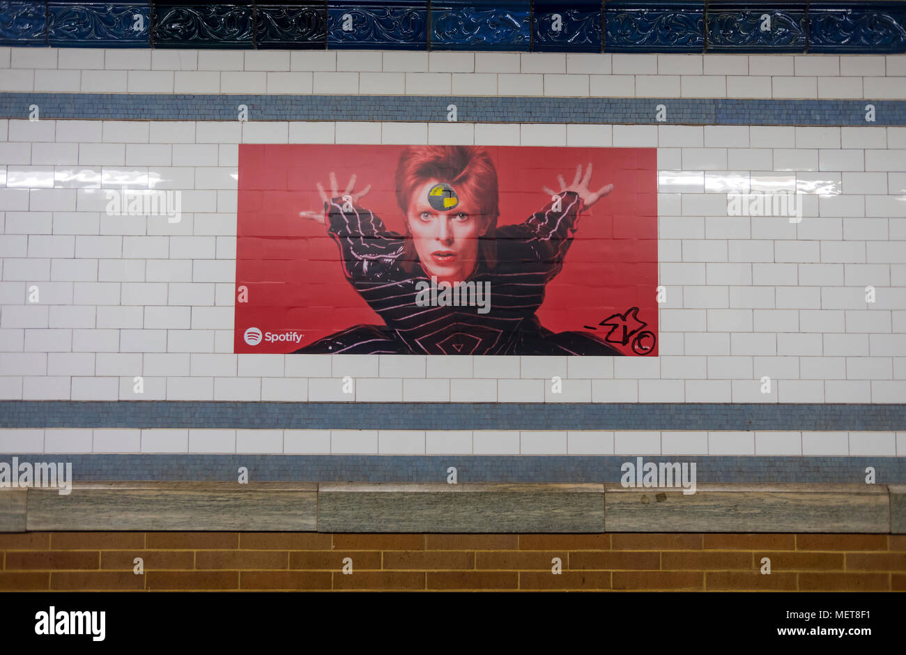 New York, USA. 121 April, 2018. One of many images of David Bowie on the Bleecker Street platform of the he Broadway-Lafayette subway station.  The installation, sponsorsed  by Spotify, is being held in conjunction with the exhibition 'David Bowie IS' at the Brooklyn. The subway installation is just blocks from where the late rock star lived in Soho. The art will be on display until mid May. ©Stacy Walsh Rosenstock Stock Photo