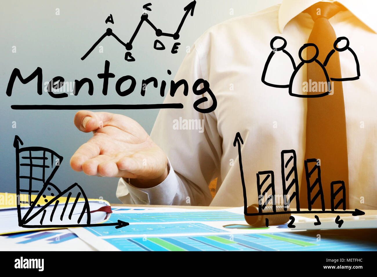 Mentoring concept. Mentor at the table in the office Stock Photo - Alamy