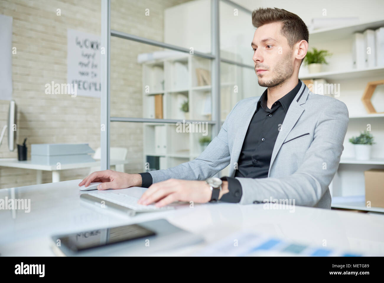 Young Manager Wrapped up in Work Stock Photo