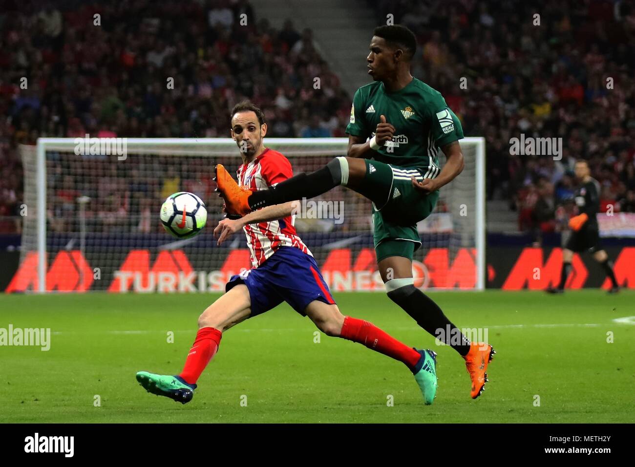 Madrid, Spain. 22nd Apr, 2018. Real Beits' Junior Firpo (R) vies with Atletico Madrid's Juanfran during the Spanish league La Liga soccer match between Atletico Madrid and Real Betis in Madrid, Spain, on April 22, 2018. The match ended 0-0. Credit: Edward Peters Lopez/Xinhua/Alamy Live News Stock Photo