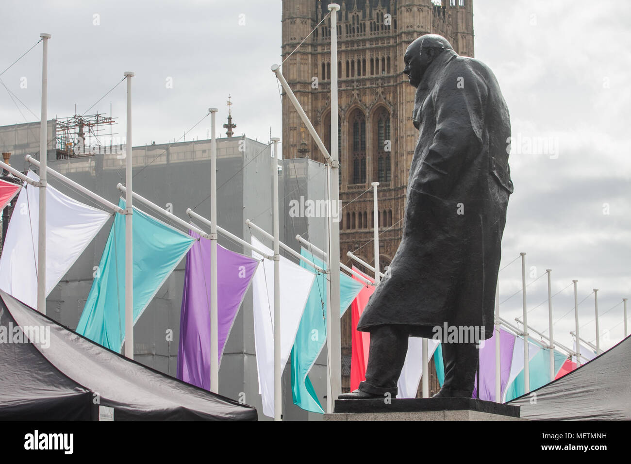 London UK. 23rd April 2018. Coloured Flags representing the Sufragette movement hang in Parliament Square in honour of Millicent Fawcett ,a British feminist, political and union leader, who campaigned for women to have the vote. In 1908 Emmeline Pethick-Lawrence, designed the suffragettes' colour scheme of purple for loyalty and dignity, white for purity, and green for hope Credit: amer ghazzal/Alamy Live News Stock Photo