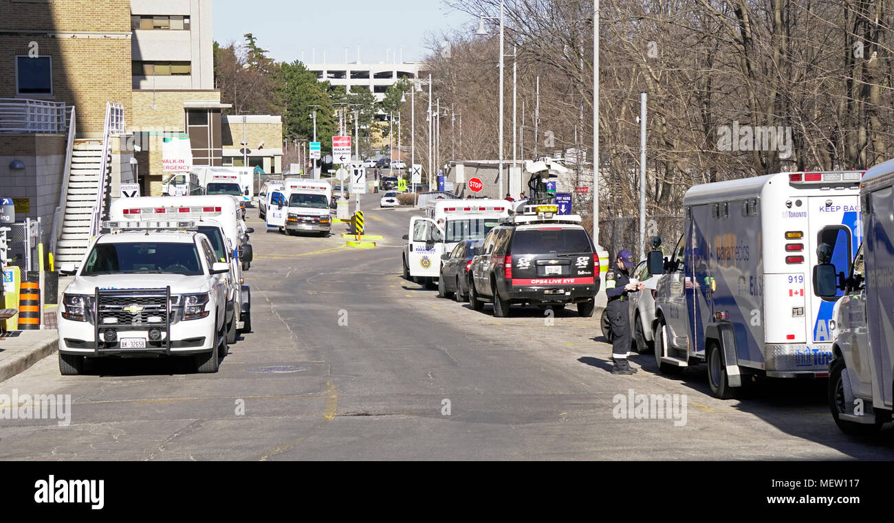 Toronto, Canada. 23rd Apr, 2018. After white van driven by Alek Minassian hit multiple victims in Toronto Yonge and Finch area, ambulances, media vehicles and police cruisers parked outside Emergency Entrance of Toronto Sunnybook Hospital Trauma Centre where victims are sent for medical treatments in the afternoon of April 23, 2018 Credit: CharlineXia/Alamy Live News Stock Photo