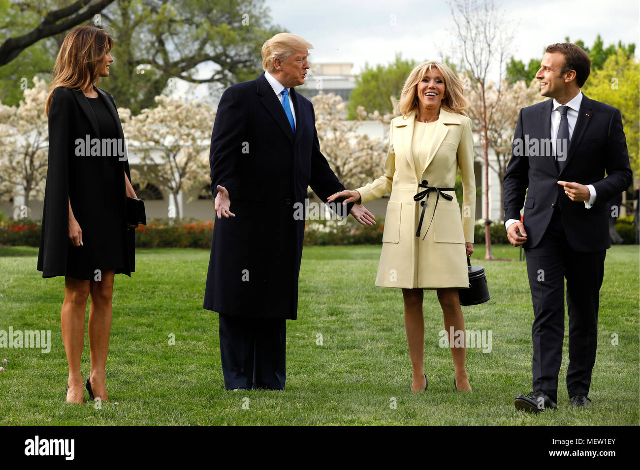 U.S. President Donald Trump with France's president Emmanuel Macron and First Ladies Melania Trump and Brigitte Macron arrive to plant a tree, a gift from the President and Mrs. Macron, on the South Lawn of the White House in Washington, DC, U.S., on Monday, April 23, 2018. As Macron arrives for the first state visit of Trump's presidency, the U.S. leader is threatening to upend the global trading system with tariffs on China, maybe Europe too. Credit: Yuri Gripas/Pool via CNP /MediaPunch Stock Photo