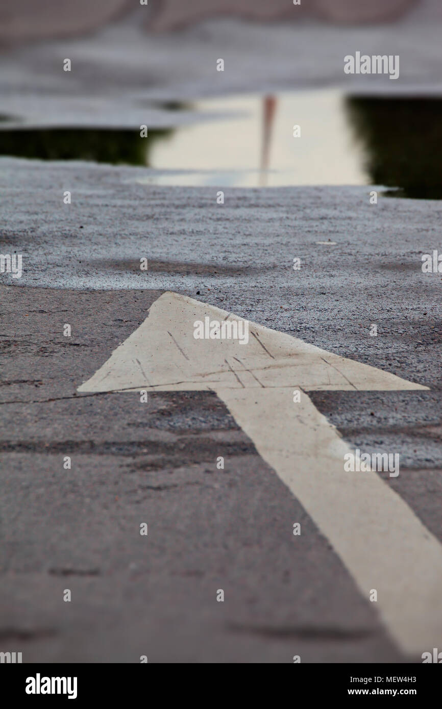 White arrow on an asphalt road Stock Photo
