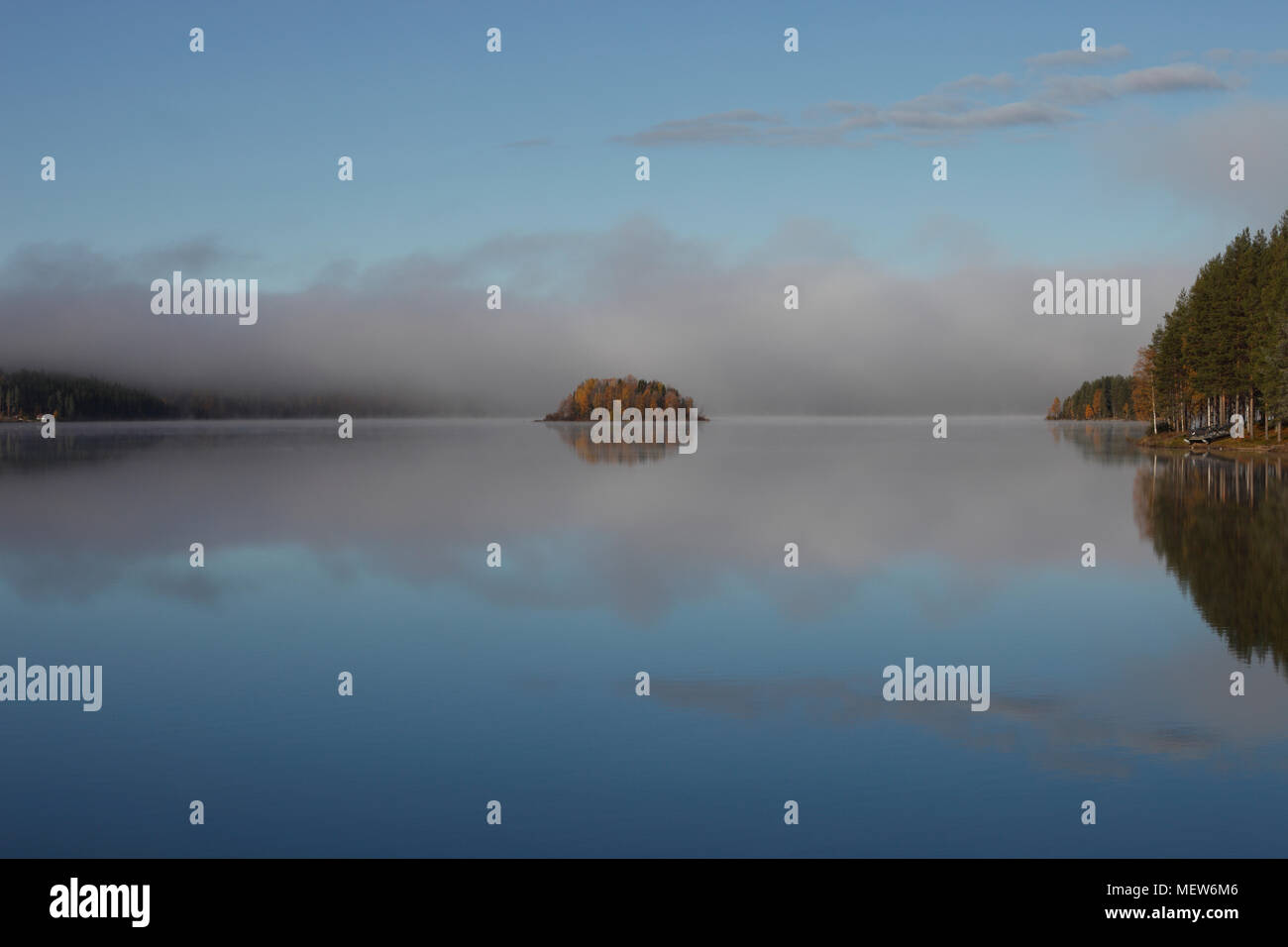 Mists are rising from a forest lake on an autumn morning Stock Photo ...