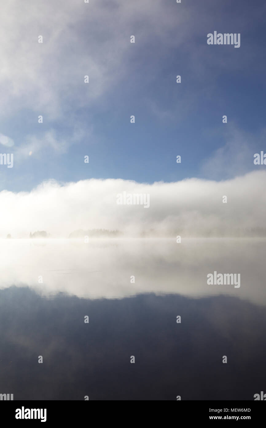 Mists are rising from a forest lake on an autumn morning Stock Photo ...