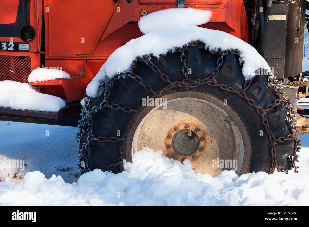 Tractor tire with snow chain Stock Photo Alamy