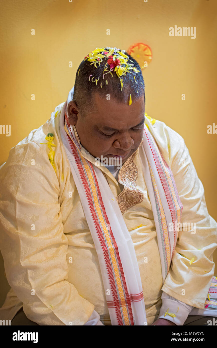 A Hindu worshiper with flowers on his head as part of a birthday ritual at the Shri Lakshmi Narayan Mandir Hindu temple in Richmond Hill, Queens, Stock Photo