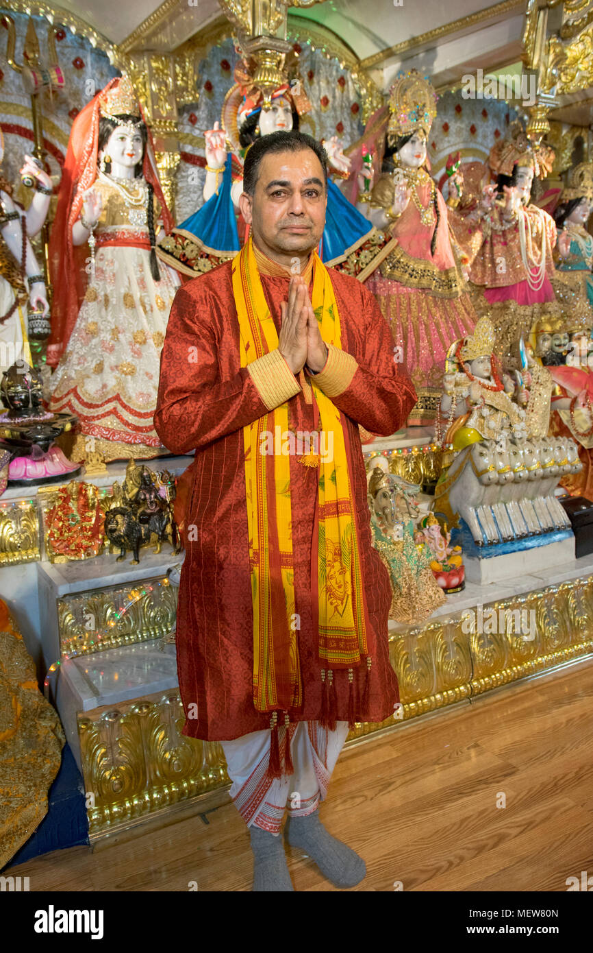 Posed portrait of a Hindu priest - or Brahmin or pundit  - at the Shri Lakshmi Narayan Mandir  temple in Richmond Hill, Queens, New York. Stock Photo