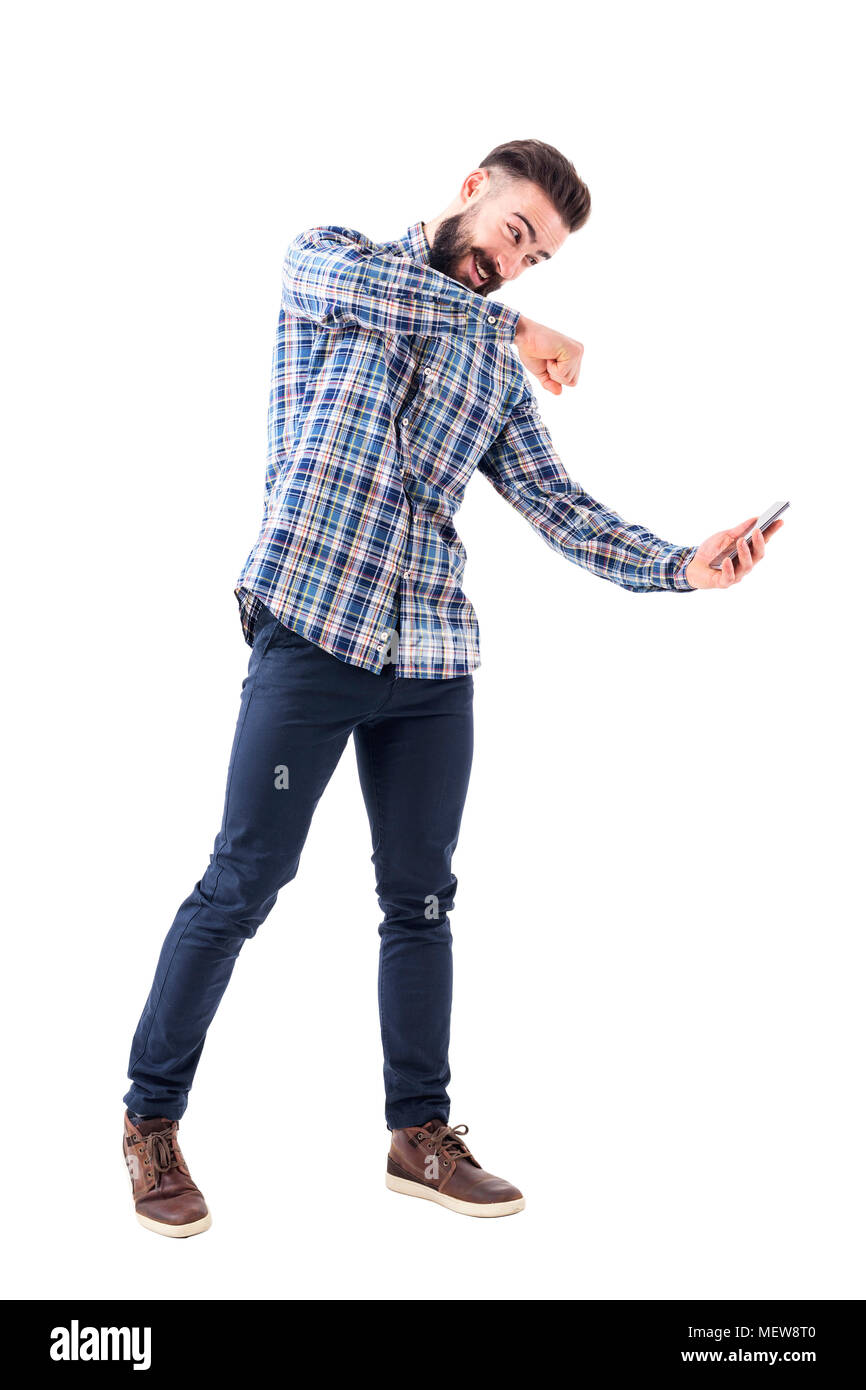 Angry bearded modern business man punching mobile phone screen. Rage