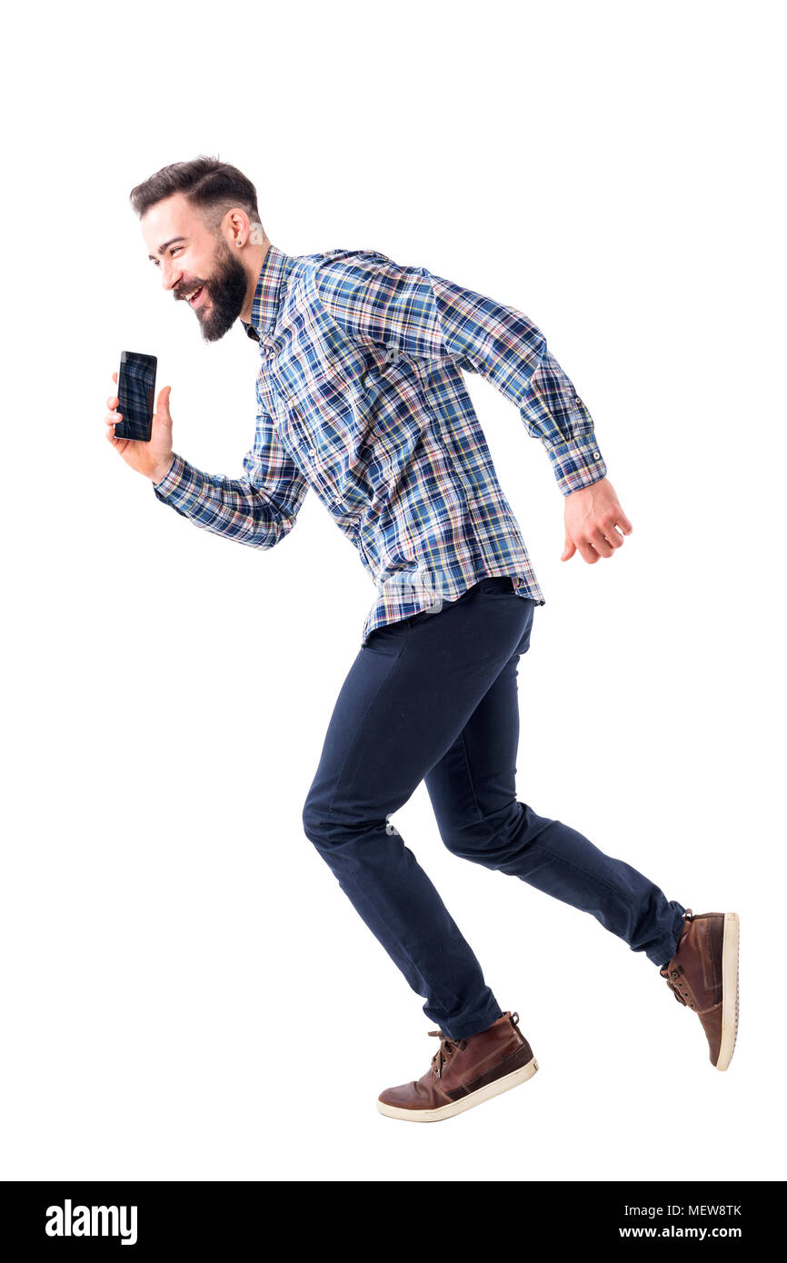 Laughing happy bearded business man running in hurry talking on the mobile phone. Full body length isolated on white background. Stock Photo