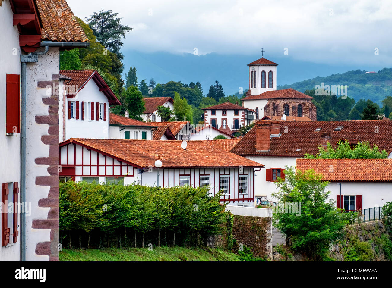 Traditional white houses and church in a basque village in the Pyrenees ...