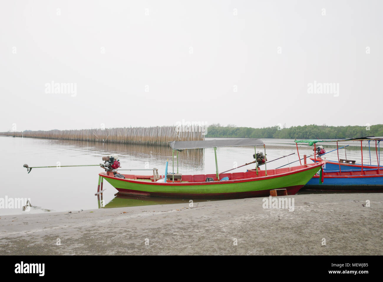 The boat parked in the mangrove forest where the floods were the sea monsoon in thailand Stock Photo